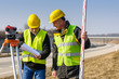 Geodesist two man theodolite stand highway