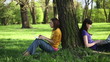 Video: Young female students with with laptop in the park, dolly shot Young female students with with laptop in the park, dolly shot