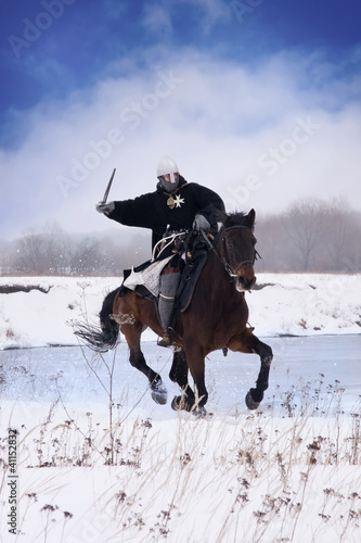 Photo: Medieval knight of St. John (Hospitallers) on a horse Medieval knight of St. John (Hospitallers) on a horse