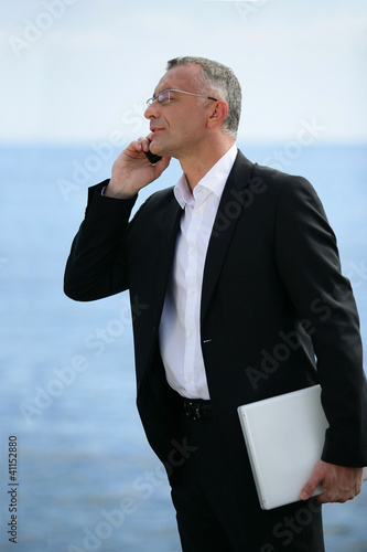 Photo: executive on the phone profile-view executive on the phone profile-view