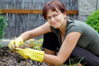 smiling middle age woman gardening in sunny day