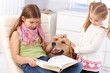 Little sisters with dog at home