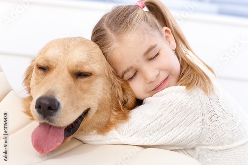 Foto: Lovely little girl and her pet dog Lovely little girl and her pet dog