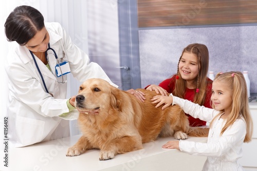 Photo: Little girls and dog at pets' clinic Little girls and dog at pets' clinic