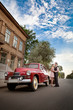 Pretty couple near the vintage car