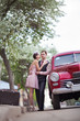 Pretty couple near the vintage car