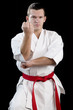 Contrast karate young fighter on black