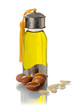 Glass bottle of argan oil with nuts and seeds