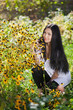 Beautiful girl with flowers in the garden