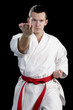 Contrast karate young fighter on black