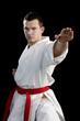 Contrast karate young fighter on black