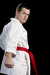 Contrast karate young fighter on black