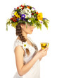 Beautiful girl in hat of flowers and cup of tea