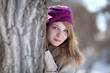 Beautiful girl peeps through the trees