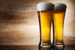 Two glass beer on wood background with copyspace