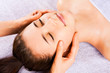 Beautiful girl receiving facial massage Beautiful girl receiving facial massage