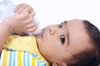 Photo: Indian baby laying witn baby bottle Indian baby laying witn baby bottle