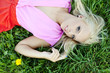 Beautiful sexy young woman outdoors, lying in the grass, relaxin