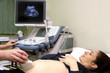 Pregnant woman and doctor hand's with ultrasound equipment
