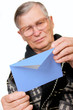 elderly man opening letter envelope