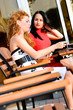 Foto: Two attractive women in street cafe Two attractive women in street cafe