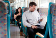 Candid image of a businessman working on a train