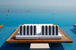 Infinity swimming pool by beach at the modern luxury hotel, Pier