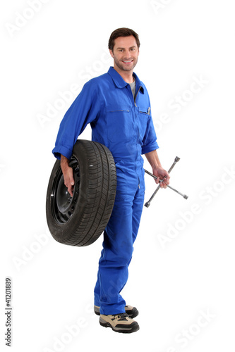 Photo: mechanic holding a tire mechanic holding a tire