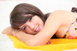 a teenage girl tanning on the beach