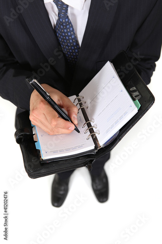Photo: Man writing in agenda Man writing in agenda