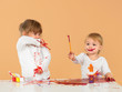 pretty baby girls painting in orange studio