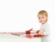 pretty baby girl painting in white studio