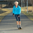Woman roller skating in park smiling summer