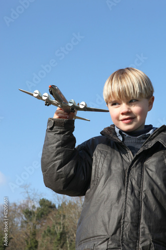 Photo: Little boy playing with toy plane Little boy playing with toy plane