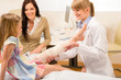 Pediatrician checking broken bandage girl leg