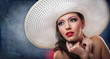 beautiful girl with hat posing in studio