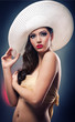 beautiful girl with hat posing in studio