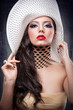beautiful girl with hat posing in studio