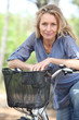 Woman riding bike in forest