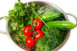 cucumbers. red tomatoes and green arugula in a metal pan