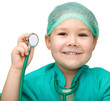 Little girl is playing doctor with stethoscope