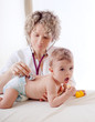 Pediatrician examining baby with stethoscope.