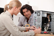 Woman fixing a computer Woman fixing a computer