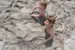 two children in sand on beach two children in sand on beach