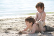two children playing on beach two children playing on beach