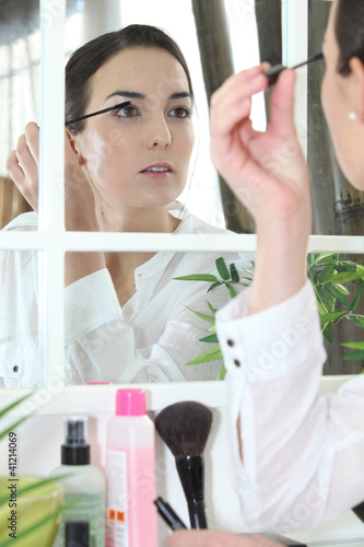 Photo: Woman applying make-up Woman applying make-up