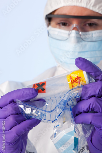 Photo: Lab technician with biohazard sample Lab technician with biohazard sample