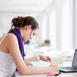 pretty female college student studying in the university library