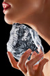 Woman holding ice to neck.