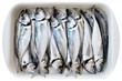 fresh cleaned fishes in dish over white